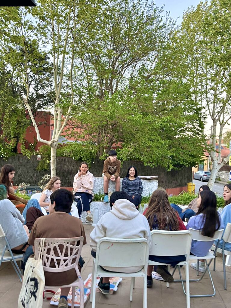 grupo de jovenes en la terraza de una escuela de arte hablando